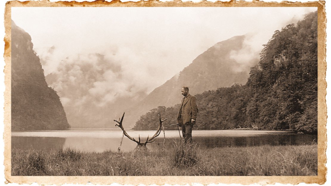 Vivian Donald amidst the backdrop of the Fiordland wilderness; his trophy bull is highlighted by Lake Katherine.